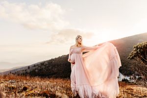 woman in pink maternity dress in North Carolina Mountains